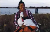  ?? JOSH SPECTOR VIA AP ?? Ariel Cordova-Rojas with Bae, a female mute swan, as the swan is rescued in the Jamaica Bay Wildlife Refuge, in the Queens borough of New York.