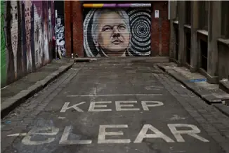  ?? AFP ?? A mural of Julian Assange adorns a roller door in a Melbourne inner-city laneway on June 20. Former Australian foreign minister Bob Carr on June 20 called for his country to demand the United States drop its prosecutio­n of the WikiLeaks founder. FREE JULIAN.