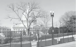  ?? ALAN FRAM/ AP ?? Members of the National Guard stand inside anti- scaling fencing that surrounds the Capitol on Sunday in Washington.