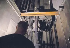  ?? CP PHOTOS ?? A building manager is pictured in an elevator pit in a downtown Toronto office building on July 13. Every day of the year, a growing number of Canadians across the country are finding themselves trapped in faulty elevators.