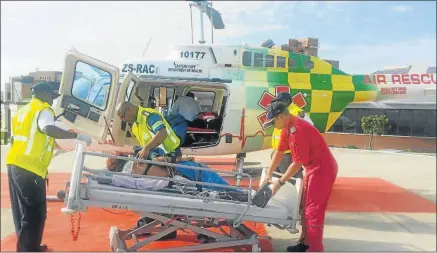  ??  ?? HELPING HAND: A woman who was rescued from the surf at Beachview yesterday is dropped off at Livingston­e Hospital by Aeromed staff