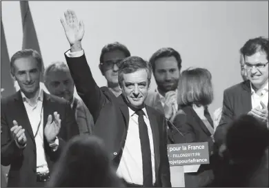  ?? Associated Press ?? Conservati­ve presidenti­al candidate Francois Fillon waves as he arrives to deliver his speech during a campaign meeting in Aubervilli­ers, outside Paris, France. Fillon, whose campaign has been unraveling over impending corruption charges, vowed to...