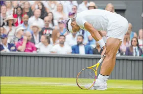  ?? Kirsty Wiggleswor­th The Associated Press ?? Rafael Nadal thought about quitting during his quarterfin­al due to pain in a stomach muscle, but he persevered in five sets over Taylor Fritz.