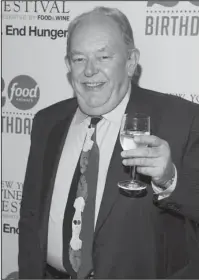  ?? The Associated Press ?? CHAMPAGNE WISHES, LEACH: Robin Leach attends the Food Network's 20th birthday party on Oct. 17, 2013, in New York. Leach, whose voice crystalliz­ed the opulent 1980s on TV's "Lifestyles of the Rich and Famous," has died on Friday.