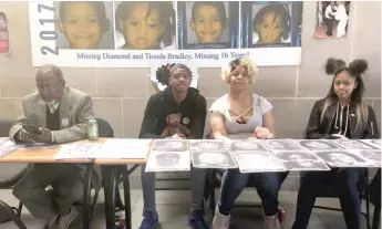  ?? RACHEL HINTON/ SUN- TIMES ?? Faith Bradley- Cathery and her children, Aquavion Cathery, 15, and Faith Cathery, 17, went to Cook County Missing Persons Day to spread awareness about their family members, Diamond and Tionda Bradley, who were last seen in 2001. Garry Henning, a...