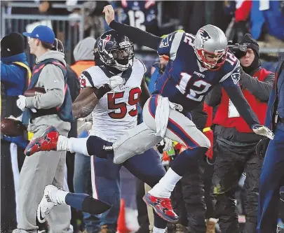  ?? STAFF PHOTO BY MATT WEST ?? TAKING FLIGHT: Houston linebacker Whitney Mercilus sends Tom Brady flying during the third quarter last night at Gillette Stadium.