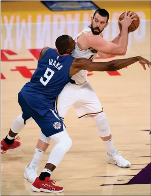  ?? Harry How / Getty Images /TNS ?? Marc Gasol #14 of the Los Angeles Lakers fends off Serge Ibaka #9 of the LA Clippers from the ball during a preseason game at Staples Center on Dec. 13 in Los Angeles.