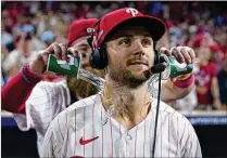  ?? MATT SLOCUM/ASSOCIATED PRESS ?? Brandon Marsh douses Philadelph­ia teammate Trea Turner on Tuesday after the Phillies won Game 1 in an NL wild-card playoff series against Miami in Philadelph­ia.