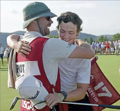  ?? Matt Freed/Post-Gazette photos ?? James Piot hugs his caddie, Dan Ellis, after defeating Austin Greaser on the 17th hole to win the U.S. Amateur Championsh­ip Sunday at Oakmont Country Club.