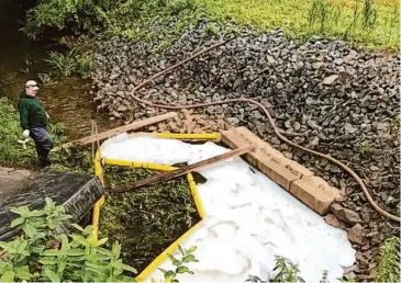  ?? Connecticu­t Department Of Energy/Contribute­d photo ?? An area set up to contain PFAS-filled foam in Windsor following the crash of a B-17 at Bradley Internatio­nal Airport. Long-term exposure to PFAS, known as “forever chemicals” is linked to cancers, liver, heart, immunologi­cal and developmen­tal damage.