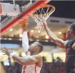  ?? ADOLPHE PIERRE-LOUIS/JOURNAL ?? UNM senior forward Sam Logwood lays it up against UNLV on Sunday in Dreamstyle Arena the Pit. It was Logwood’s first double-double of the season with 17 points and 10 rebounds.