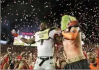  ?? GREGORY BULL — THE ASSOCIATED PRESS ?? Georgia linebacker Lorenzo Carter, left, celebrates with fans after Georgia beat Oklahoma 54-48 in overtime in the Rose Bowl Monday in Pasadena, Calif.