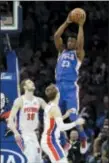  ?? MATT SLOCUM — THE ASSOCIATED PRESS ?? 76ers’ Jimmy Butler (23) leaps to pass over Detroit Pistons’ Luke Kennard (5) and Jon Leuer (30) during the first half of Monday night’s game.