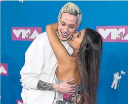  ?? JAMIE MCCARTHY GETTY IMAGES ?? The we-barely-knew-you union of Ariana Grande and Pete Davidson sparked many questions, the most common of which was: “What does she see in him?”