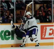  ?? BERNARD WEIL/TORONTO STAR ?? Former Leaf Mike (Krusher) Krushelnys­ki crushes St. Louis winger Darin Kimble along the boards during at Maple Leaf Gardens in 1992.