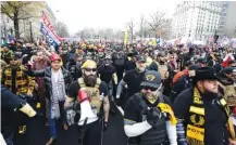  ?? AP PHOTO/LUIS M. ALVAREZ ?? Wearing Proud Boy gear, supporters of President Donald Trump attend a rally at Freedom Plaza on Saturday, in Washington.