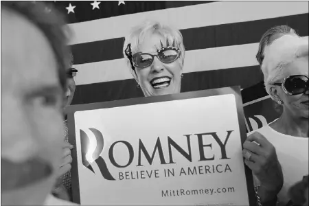  ?? Joe Raedle, Gety Image
s ?? Jackie Nigro shows her support for Republican presidenti­al candidate Mitt Romney during a rally Monday in Dunedin, Fla.