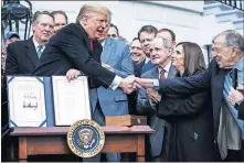  ?? [JABIN BOTSFORD/WASHINGTON POST] ?? President Donald Trump on Wednesday participat­es in a signing ceremony for the United States-Mexico-Canada Trade Agreement at the White House.