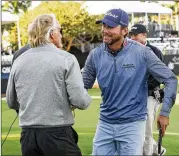  ?? LOGAN NEWELL / NAPLES DAILY NEWS ?? Sean O’Hair (right) shakes Greg Norman’s hand after O’Hair and partner Steve Stricker shot 8-under 64 to win the QBE Shootout.