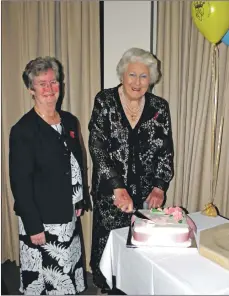  ??  ?? Lady Jean cuts her 90th birthday cake with the late Morag Gardner at the SWRI annual dinner.