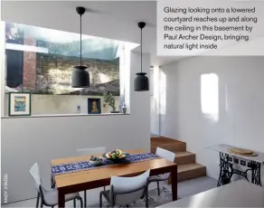  ??  ?? Glazing looking onto a lowered courtyard reaches up and along the ceiling in this basement by Paul Archer Design, bringing natural light inside