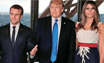  ??  ?? Paris trip: Mr Trump with wife Melania and French president Emmanuel Macron