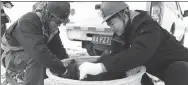  ?? ZHU YIRAN / FOR CHINA DAILY ?? Workers assemble an insulated nest that prevents birds from being injured or killed on electrical towers.