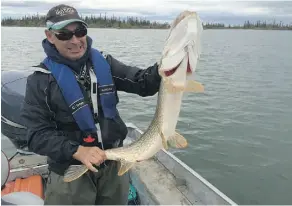  ?? SEAN MALLEN ?? Charlie Kudlak, a guide with Yellowknif­e Outdoor Adventures, holds a 42-inch pike caught by a client on a day trip on Yellowknif­e Bay.