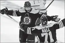  ?? MICHAEL DWYER/AP PHOTO ?? Craig Smith of the Boston Bruins celebrates his goal with Taylor Hall during the first period of Saturday’s game against the Buffalo Sabres.