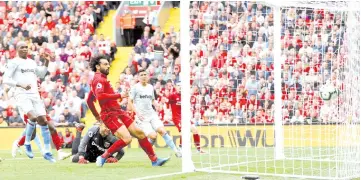  ?? — Reuters photo ?? Liverpool’s Salah scores their first goal during the English Premier League match between Liverpool v West Ham United at Anfield in Liverpool.