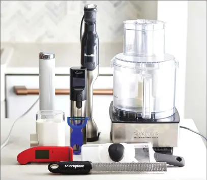  ?? Associated Press photo ?? This photo shows an assortment of kitchen gadgets in New York, including a food processor, back right.