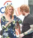  ?? DIMITRIOS KAMBOURIS, GETTY IMAGES ?? Kelly spoke with Ed Sheeran at Rockefelle­r Plaza in July.