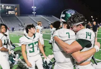  ?? Sam Owens/Staff photograph­er ?? Reagan’s Brad Jackson, front left, embraces teammate Caleb Cappuccio after their 45-28 loss to Westlake on Friday in the Class 6A Division I second-round playoff game in Seguin.