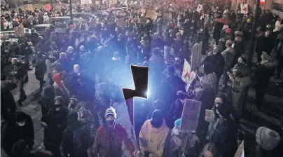  ?? PHOTO: REUTERS ?? People power . . . A demonstrat­or holds a cutout with the symbol of the Strajk Kobiet (Women's Strike) movement during a protest following a court ruling imposing a neartotal abortion ban, in Warsaw, Poland yesterday.