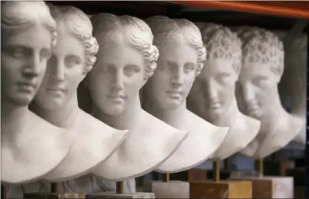  ?? PHOTOS BY THANASSIS STAVRAKIS — THE ASSOCIATED PRESS ?? Plaster replicas of Hygeia, ancient deity of health, are placed on a shelf storage in Culture Ministry’s Lab in Athens.