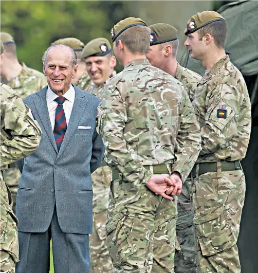  ??  ?? The Duke of Edinburgh meets troops in his role as Colonel of the Grenadier Guards