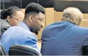  ?? SUN SENTINEL ?? Devonte White, 26, speaks with attorney Thomas Weiss on Monday during his trial for a first-degree murder charge in the May 2014 death of I’zarion Colin, 1.