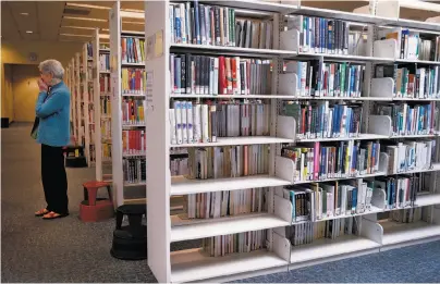  ?? Photos Brant Ward / The Chronicle ?? Dorothea Dorenz, a member of Library Book Savers of Alameda County, checks out the Fremont main library.