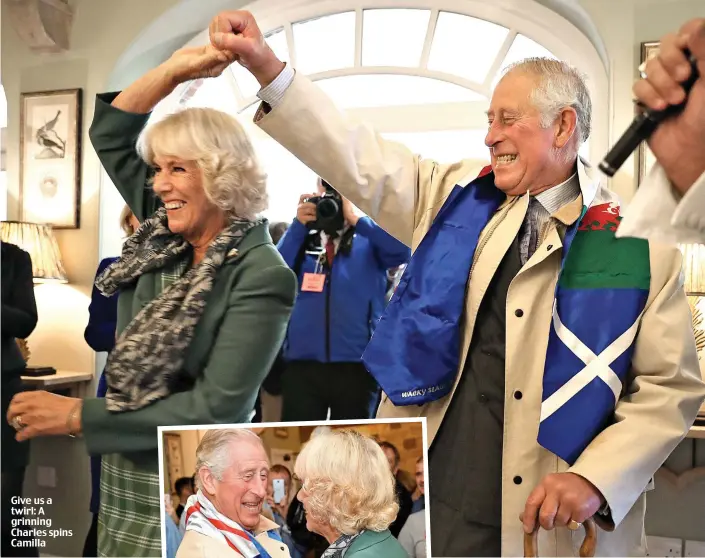  ??  ?? Give us a twirl: A grinning Charles spins Camilla