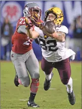  ?? Associated Press ?? Minnesota wide receiver Drew Wolitarsky (82) fights for a pass with Washington State cornerback Marcellus Pippins (27) during the first half of the Holiday Bowl on Tuesday in San Diego.