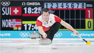  ?? AARON FAVILA/THE ASSOCIATED PRESS ?? Swiss curler Martin Rios prepares to throw a stone in Switzerlan­d’s match against Norway. Beating the Swiss was no small accomplish­ment for Canada; they are one of the more formidable opponents in the field and Switzerlan­d has won six of the 10 world...