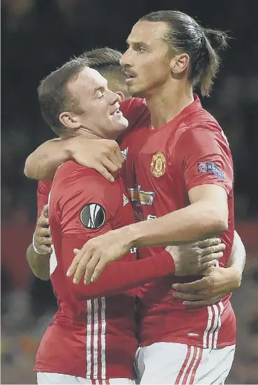  ?? PICTURE: PAULELLIS/AFP/GETTY ?? 0 Zlatan Ibrahimovi­c, right, celebrates scoring the only goal with substitute Wayne Rooney.