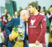  ?? JOHN SUDBRINK/FREELANCE FILE ?? Poquoson assistant basketball coach Parker Topping hugs his son, Parker Topping Jr., during Poquoson’s senior night on Feb. 14, 2020.