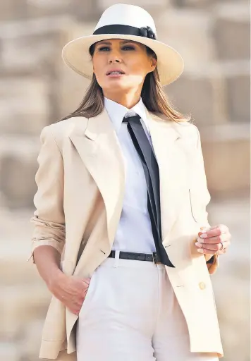  ??  ?? It could be an image lifted straight from the pages of a catalogue, but this was an official photograph of Melania Trump visiting the Giza pyramids in Egypt yesterday. Mrs Trump wore white slacks, a cream jacket and a panama hat as she wound up her African trip