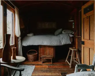  ??  ?? ABOVE One of the beautifull­y hewn railway carriages available for overnight rentals at Settle. Owned by John and Jo Morfoot, of Morways reclamatio­n yard, the site is built entirely from reclaimed materials. FACING PAGE, CLOCKWISE FROM TOP LEFT
At LASSCO Three Pigeons, a Beaux Arts marble doorcase frames the entrance to a parcel-gilt oak dining room rescued from an English country house; stylish Ercol rocking chairs on display at Retrouvius; a flock of fanlight windows suspended mid-flight at LASSCO Three Pigeons.