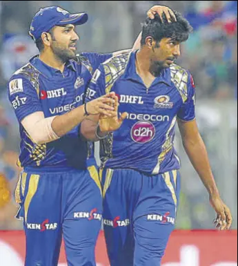  ?? AP ?? Mumbai Indians' Jasprit Bumrah is congratula­ted by skipper Rohit Sharma after he dismissed Sunrisers Hyderabad's Ben Cutting in Mumbai on Wednesday. Bumrah took three wickets for 24 runs.