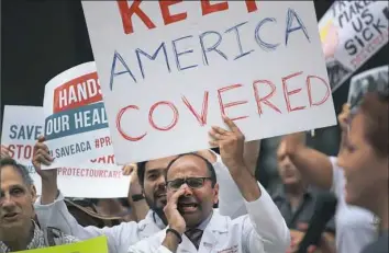  ?? Scott Olson/Getty Images ?? Demonstrat­ors protest changes to the Affordable Care Act on Thursday in Chicago.
