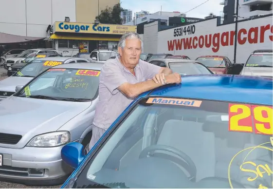  ?? Picture: GLENN HAMPSON ?? Cougar Cars owner Harry Roberts fears he may have to close his Southport dealership during the Commonweal­th Games.