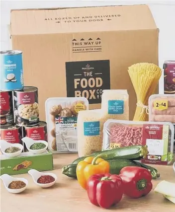  ??  ?? The family food box is filled with fresh and dry ingredient­s and includes simple recipe cards