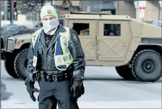  ?? GETTY IMAGES ?? A police member stands in the cold during preparatio­ns for the Super Bowl.